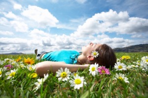 Girl Laying in a Field with Flowers